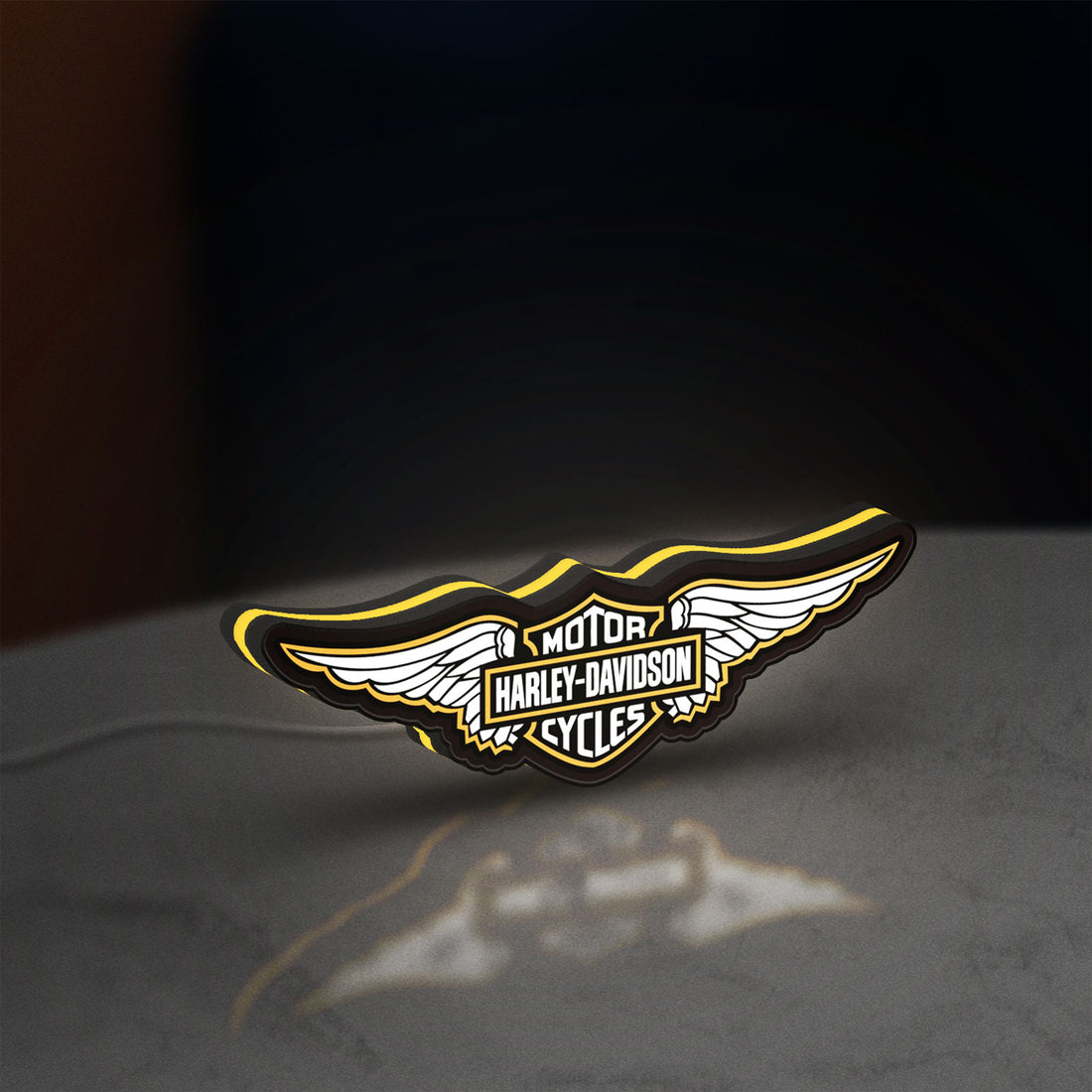 Harley Davidson Wings LED lightbox hanging on a wall with yellow glow