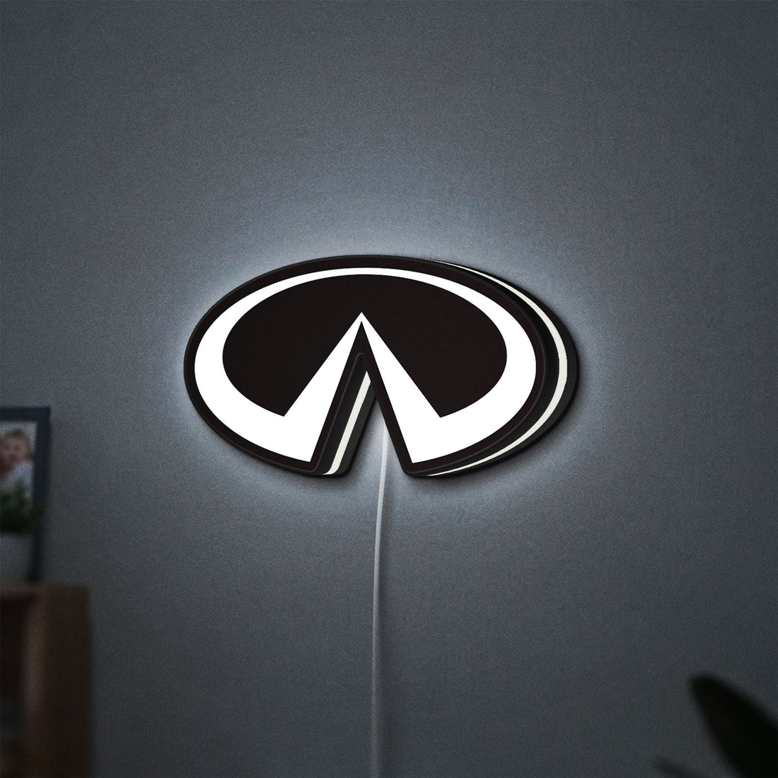 Infiniti LED lightbox hanging on a wall with white glow