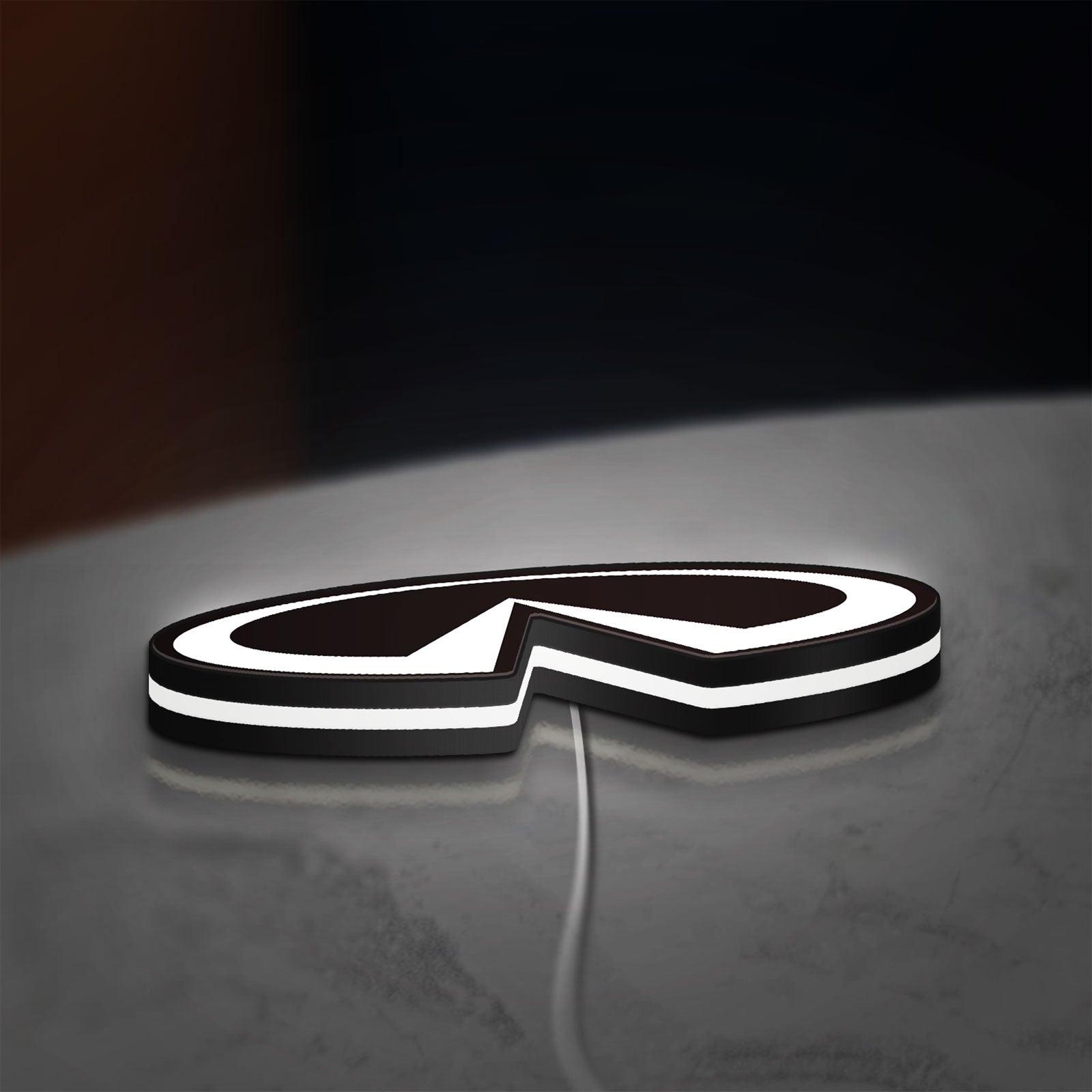 Infiniti LED lightbox lying flat on a desk with white glow