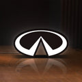 Front view of Infiniti LED lightbox sign glowing on a wooden desk