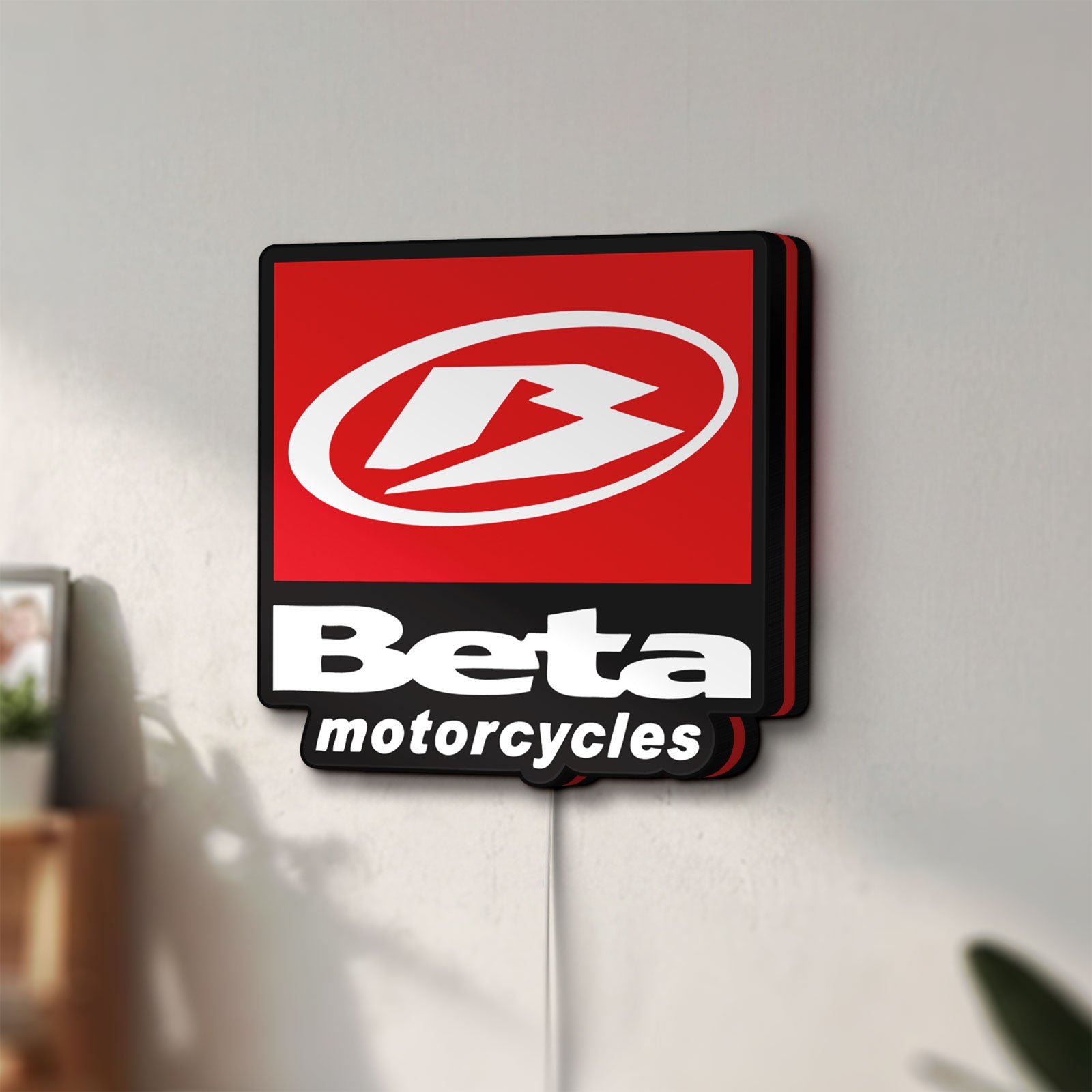 Unlit Beta Italian Motorcycles LED lightbox mounted on a wall in daylight
