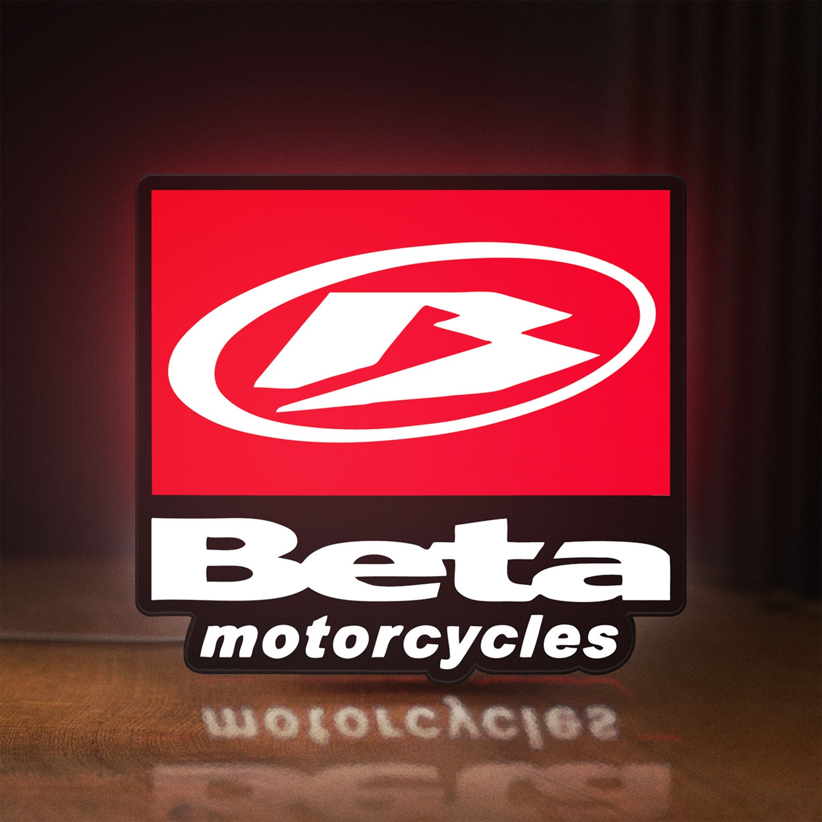 Front view of Beta Italian Motorcycles LED lightbox sign glowing on a wooden desk