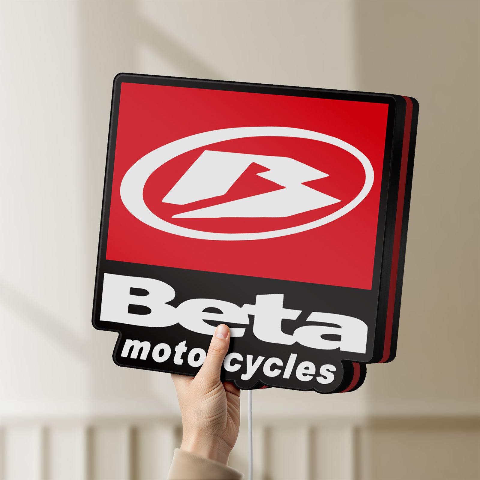 Unlit Beta Italian Motorcycles LED lightbox held by hand to show size and details