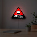 Spoon Sports LED lightbox hanging on a room wall with soft red light