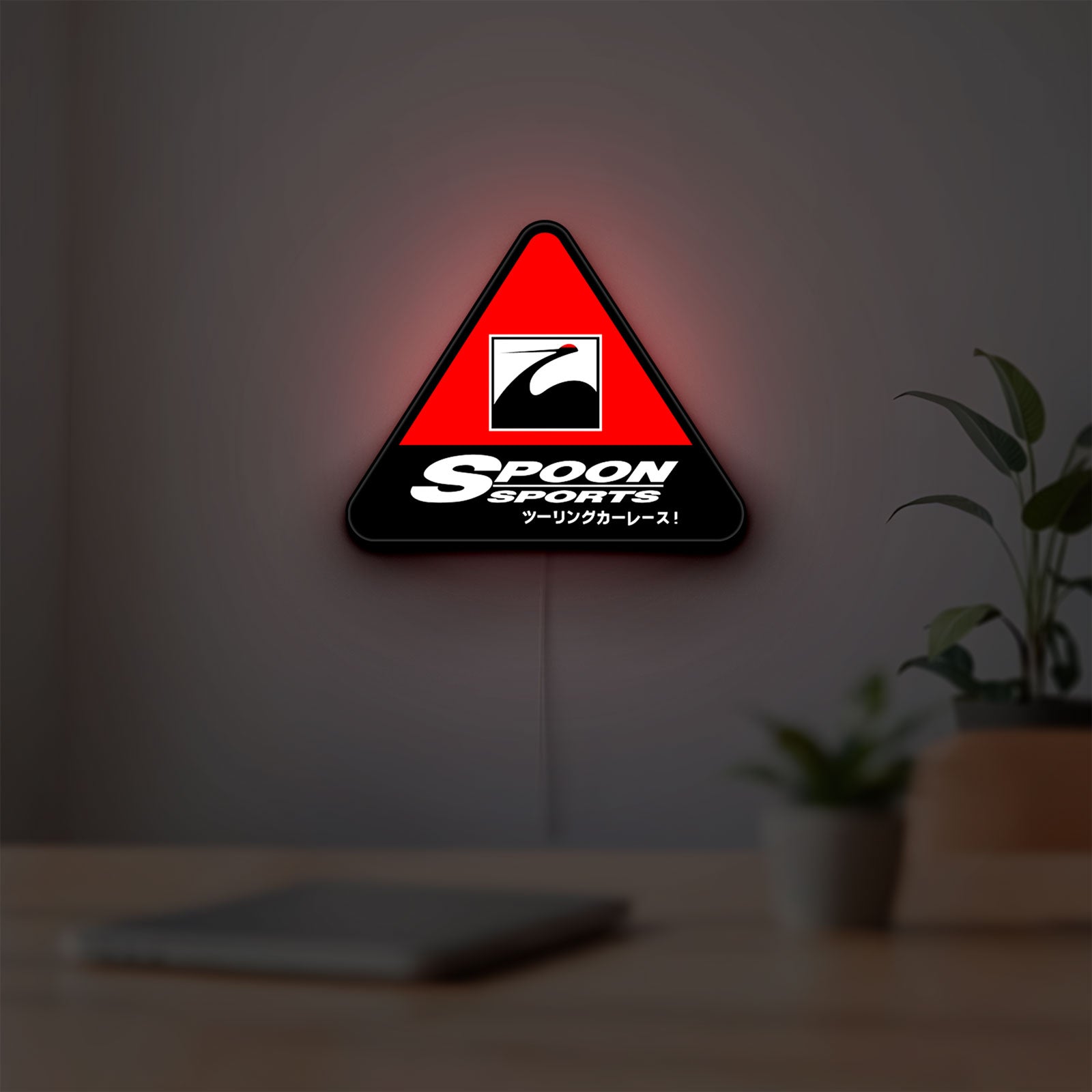 Spoon Sports LED lightbox hanging on a room wall with soft red light