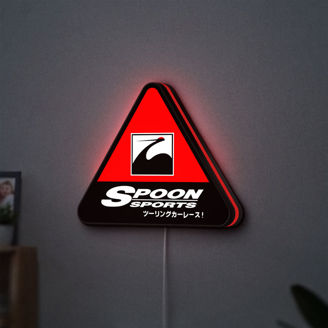 Spoon Sports LED lightbox hanging on a wall with red glow