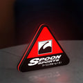 Spoon Sports LED lightbox standing on a desk from an angled side view with red glow