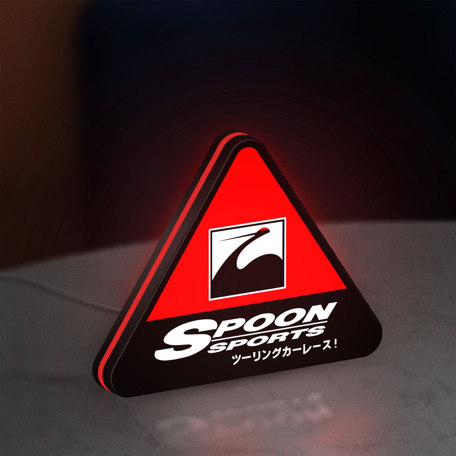 Spoon Sports LED lightbox standing on a desk from an angled side view with red glow