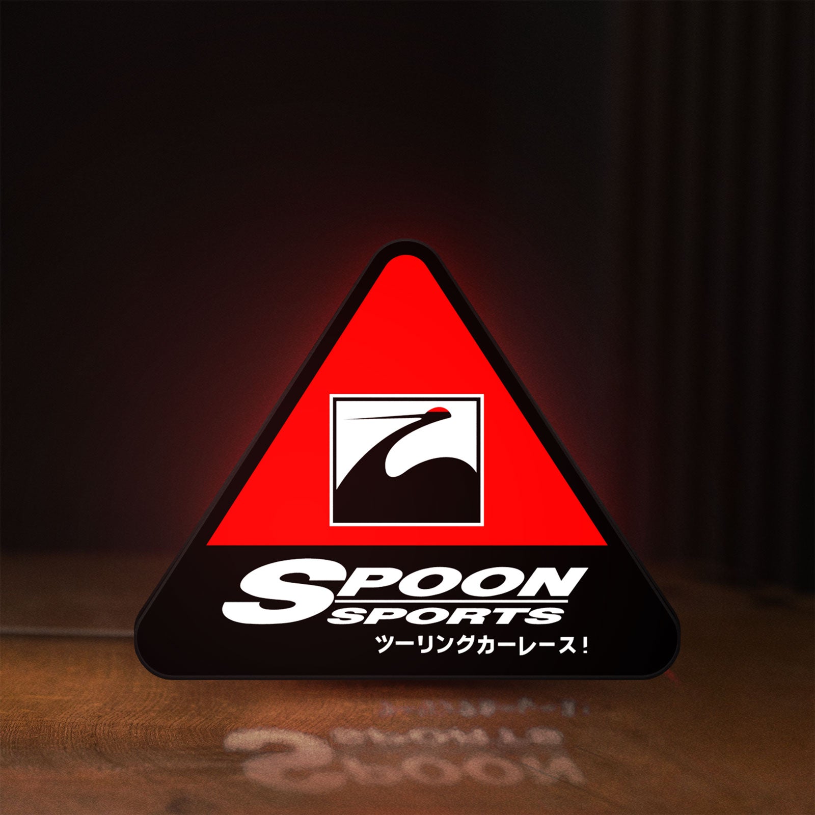 Front view of Spoon Sports LED lightbox sign glowing on a wooden desk