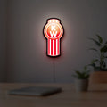 Kenworth LED lightbox hanging on a room wall with soft red light