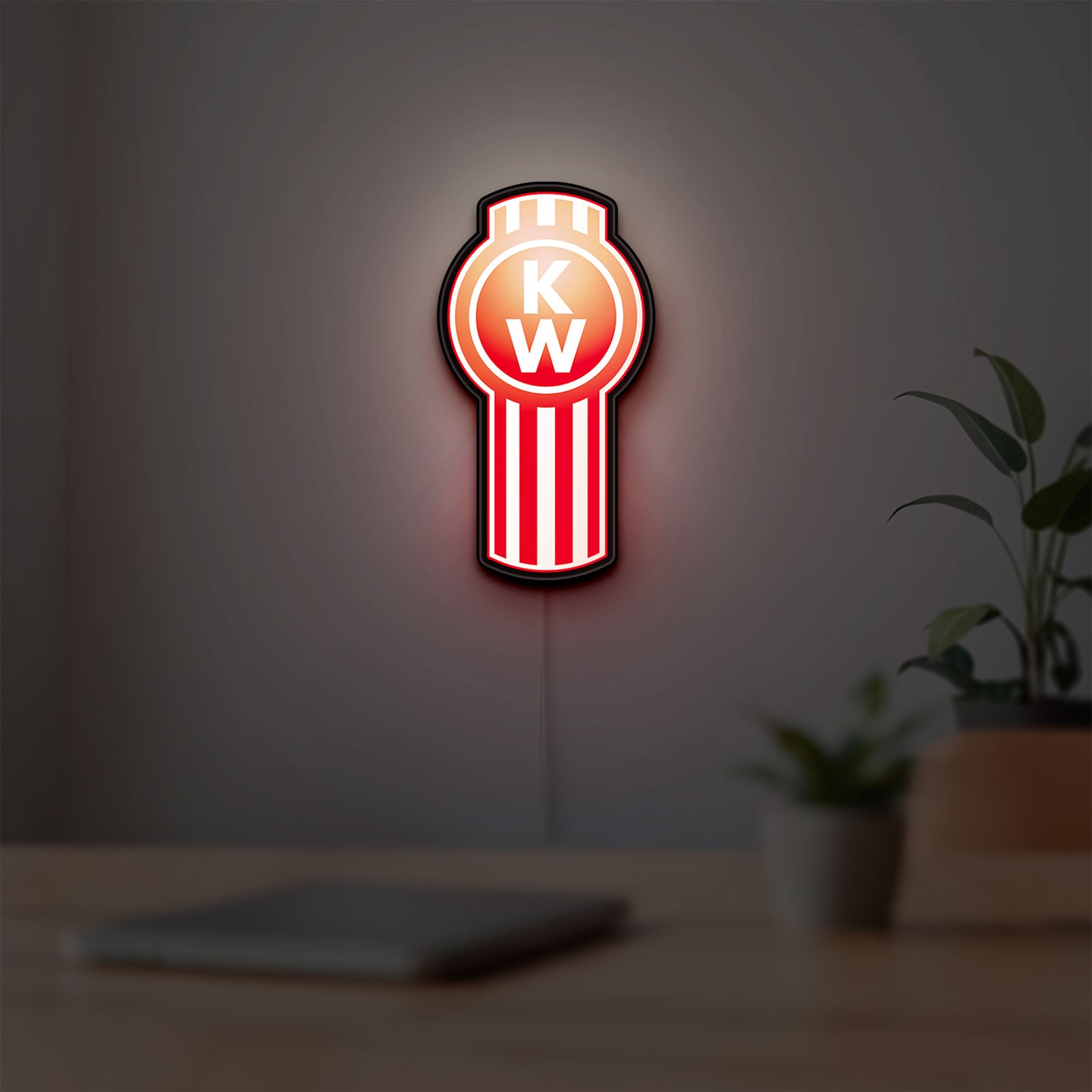 Kenworth LED lightbox hanging on a room wall with soft red light