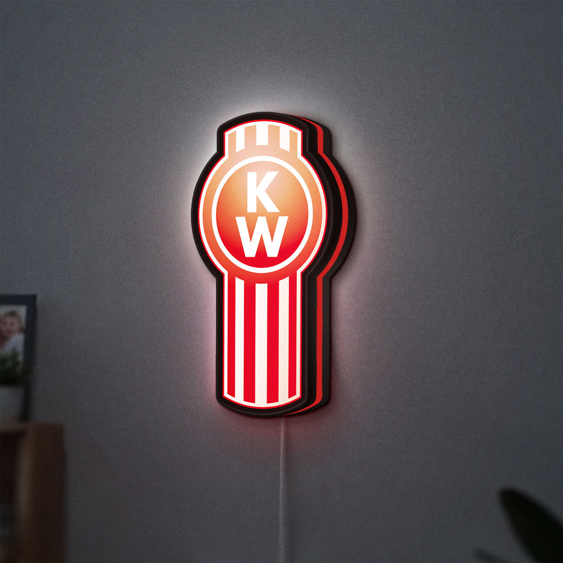 Kenworth LED lightbox hanging on a wall with red glow