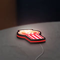 Kenworth LED lightbox lying flat on a desk with red glow