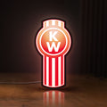 Front view of Kenworth LED lightbox sign glowing on a wooden desk