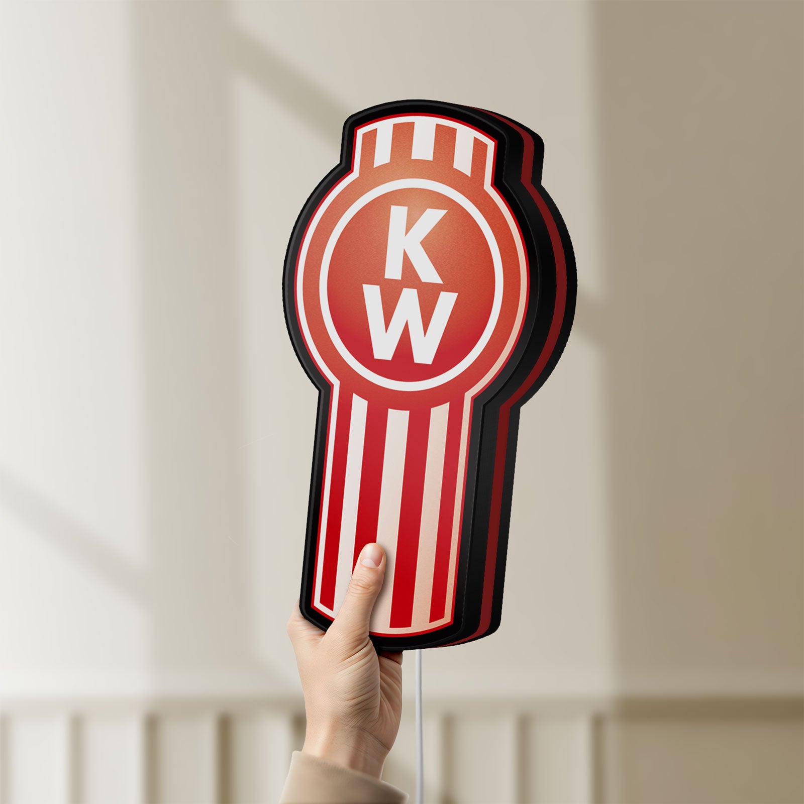 Unlit Kenworth LED lightbox held by hand to show size and details