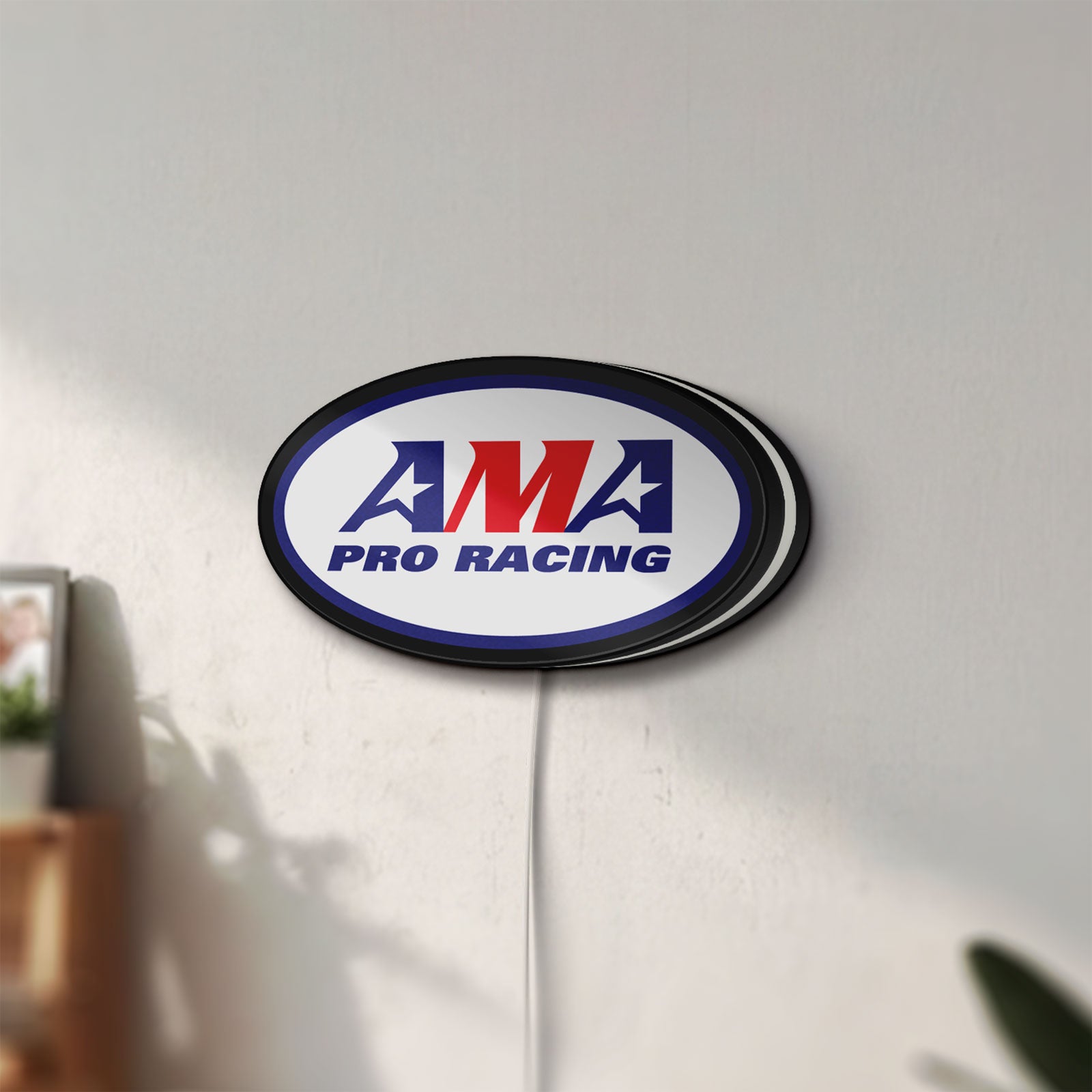 Unlit AMA Pro Racing LED lightbox mounted on a wall in daylight
