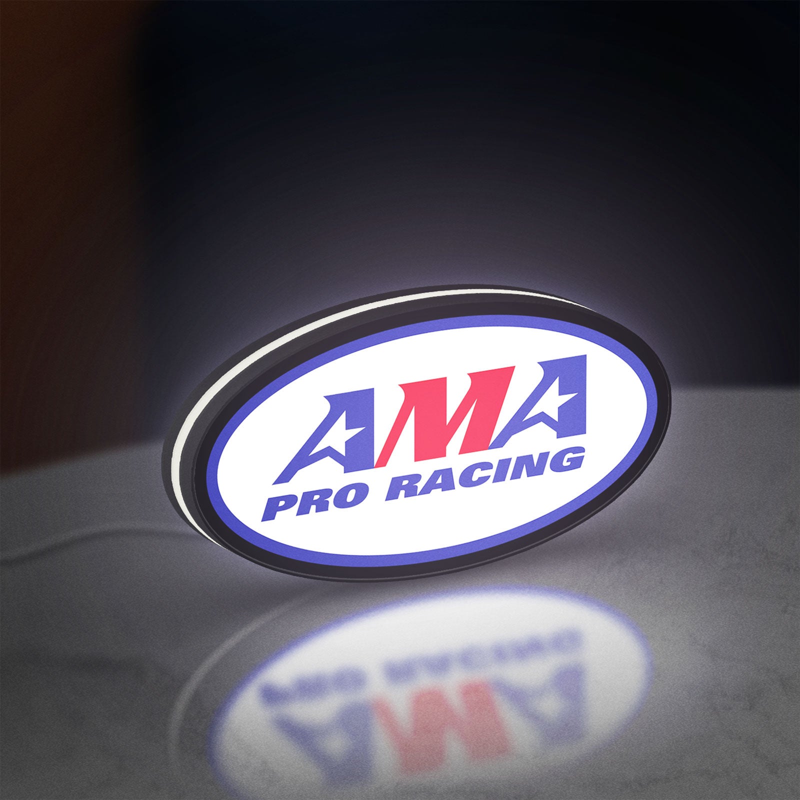 AMA Pro Racing LED lightbox standing on a desk from an angled side view with white glow