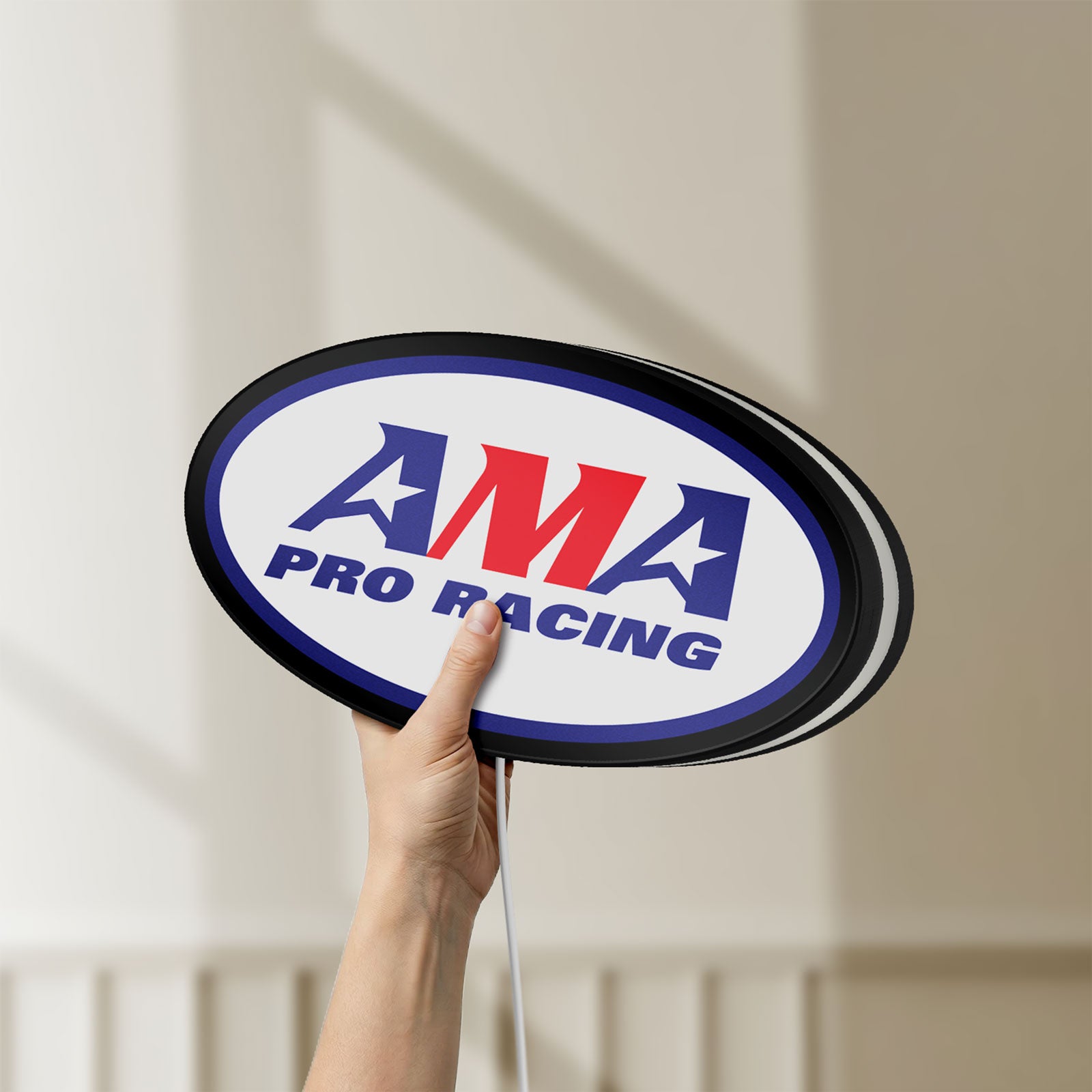 Unlit AMA Pro Racing LED lightbox held by hand to show size and details