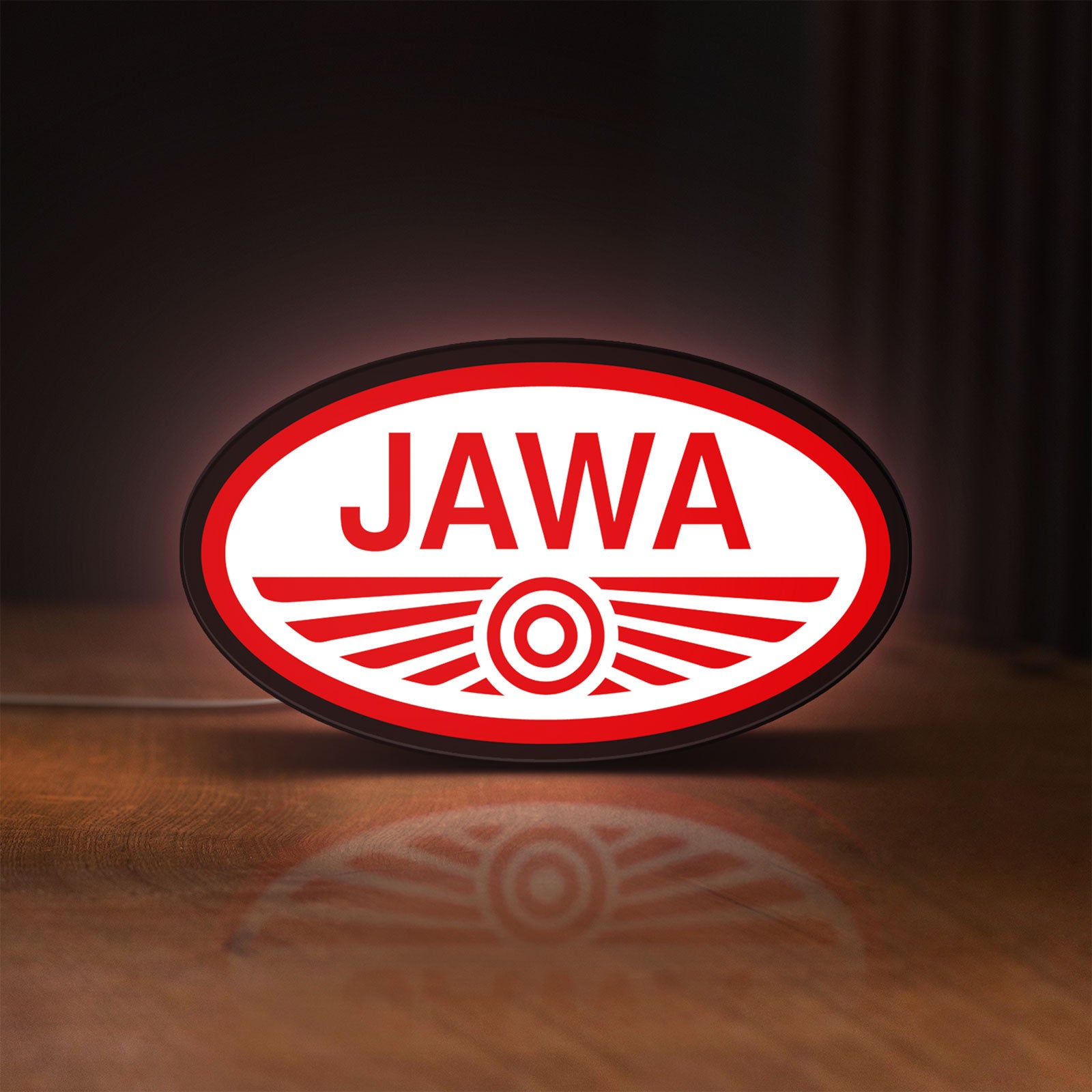 Front view of Jawa Motorcycle LED lightbox sign glowing on a wooden desk