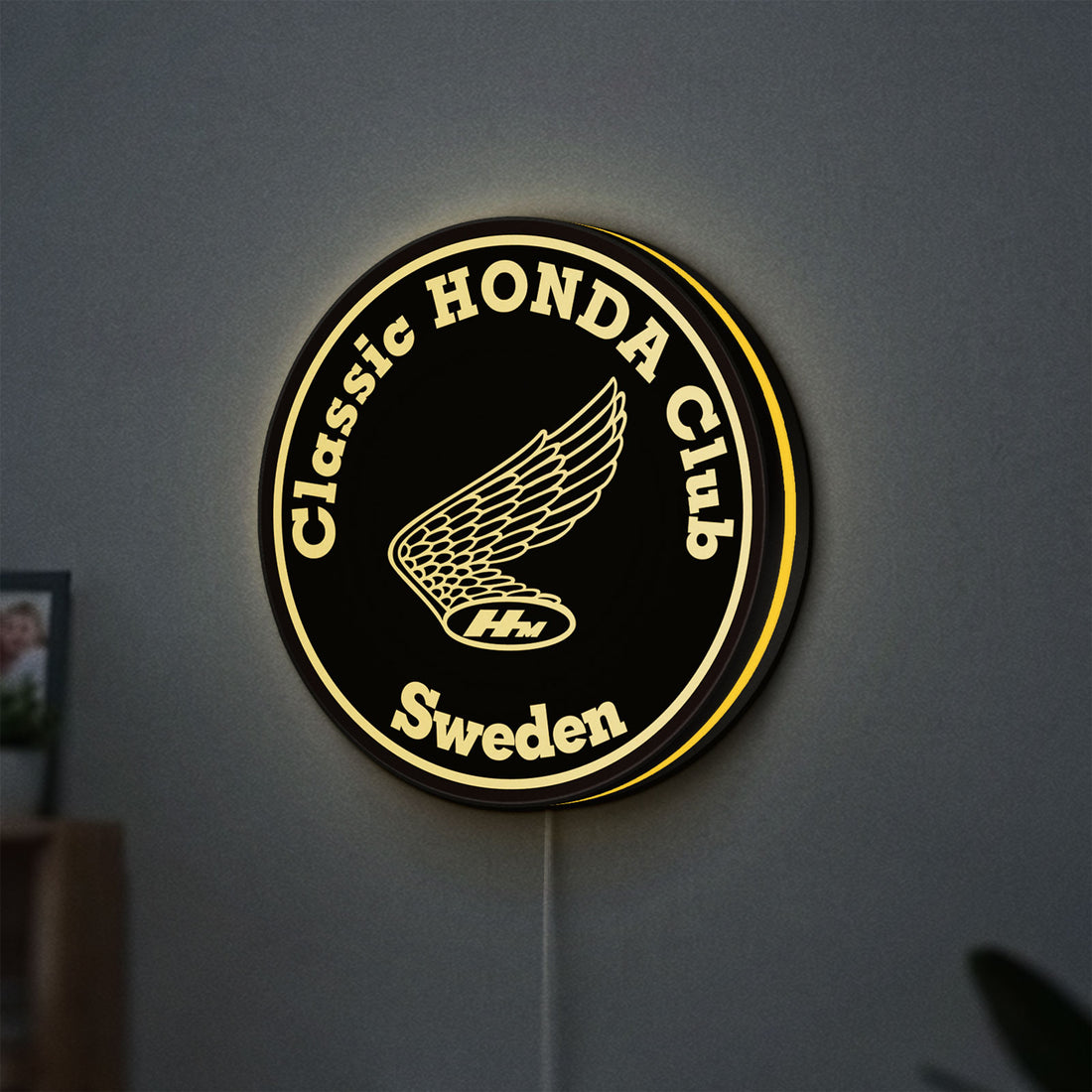 Classic Honda Racing Club LED lightbox hanging on a wall with yellow glow