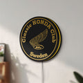 Unlit Classic Honda Racing Club LED lightbox mounted on a wall in daylight