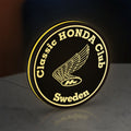 Classic Honda Racing Club LED lightbox standing on a desk from an angled side view with yellow glow