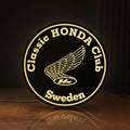 Front view of Classic Honda Racing Club LED lightbox sign glowing on a wooden desk