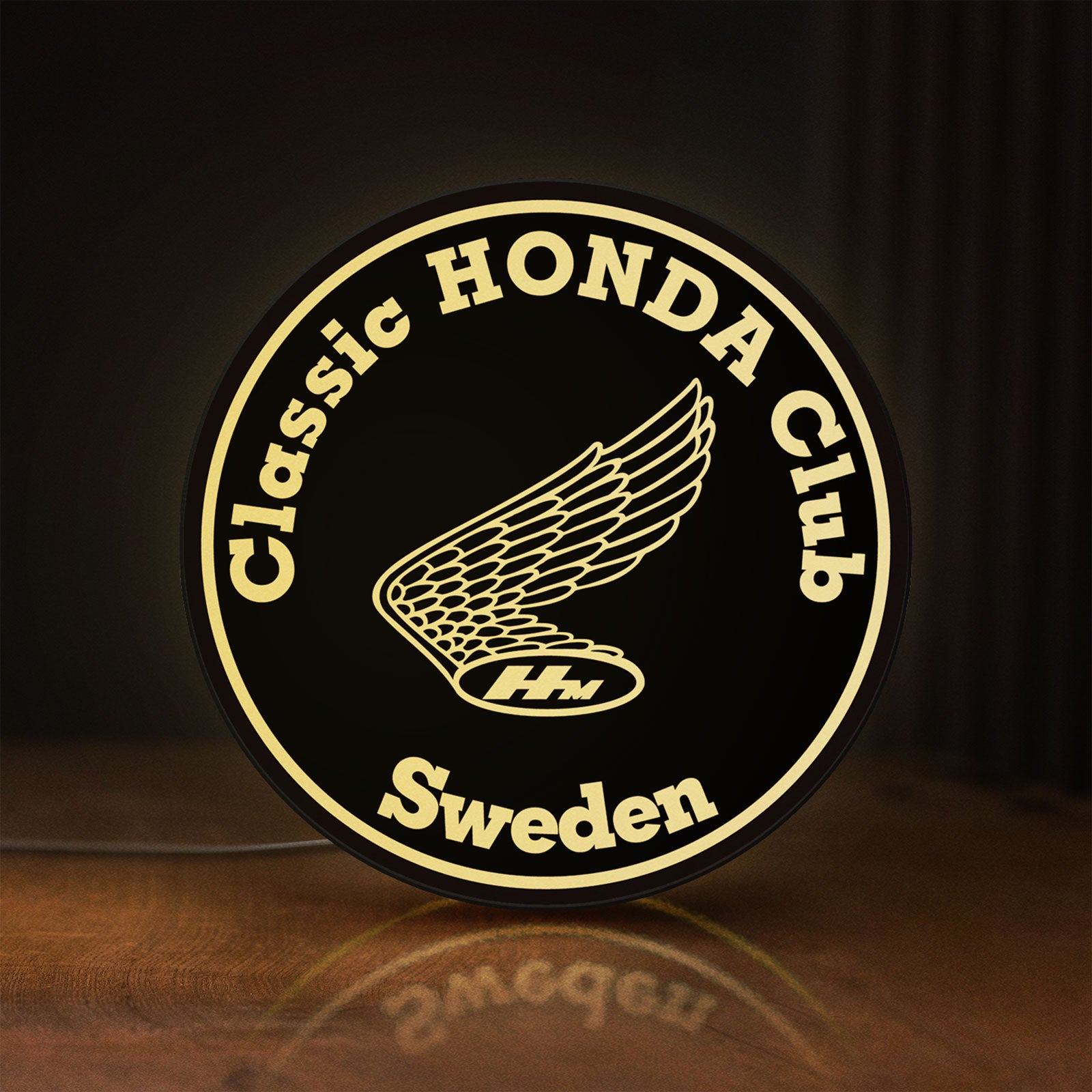 Front view of Classic Honda Racing Club LED lightbox sign glowing on a wooden desk