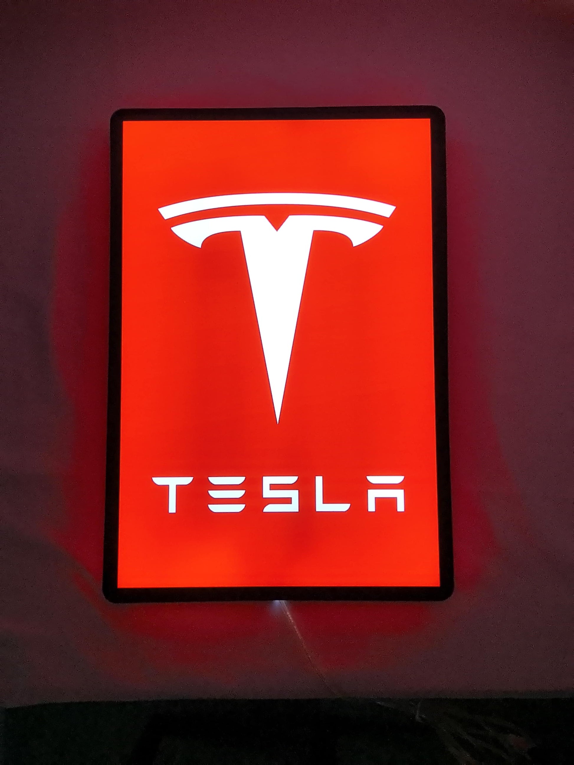Tesla LED Sign (40cm) - Illuminated flat lay front view, perfect for garage and man cave decor