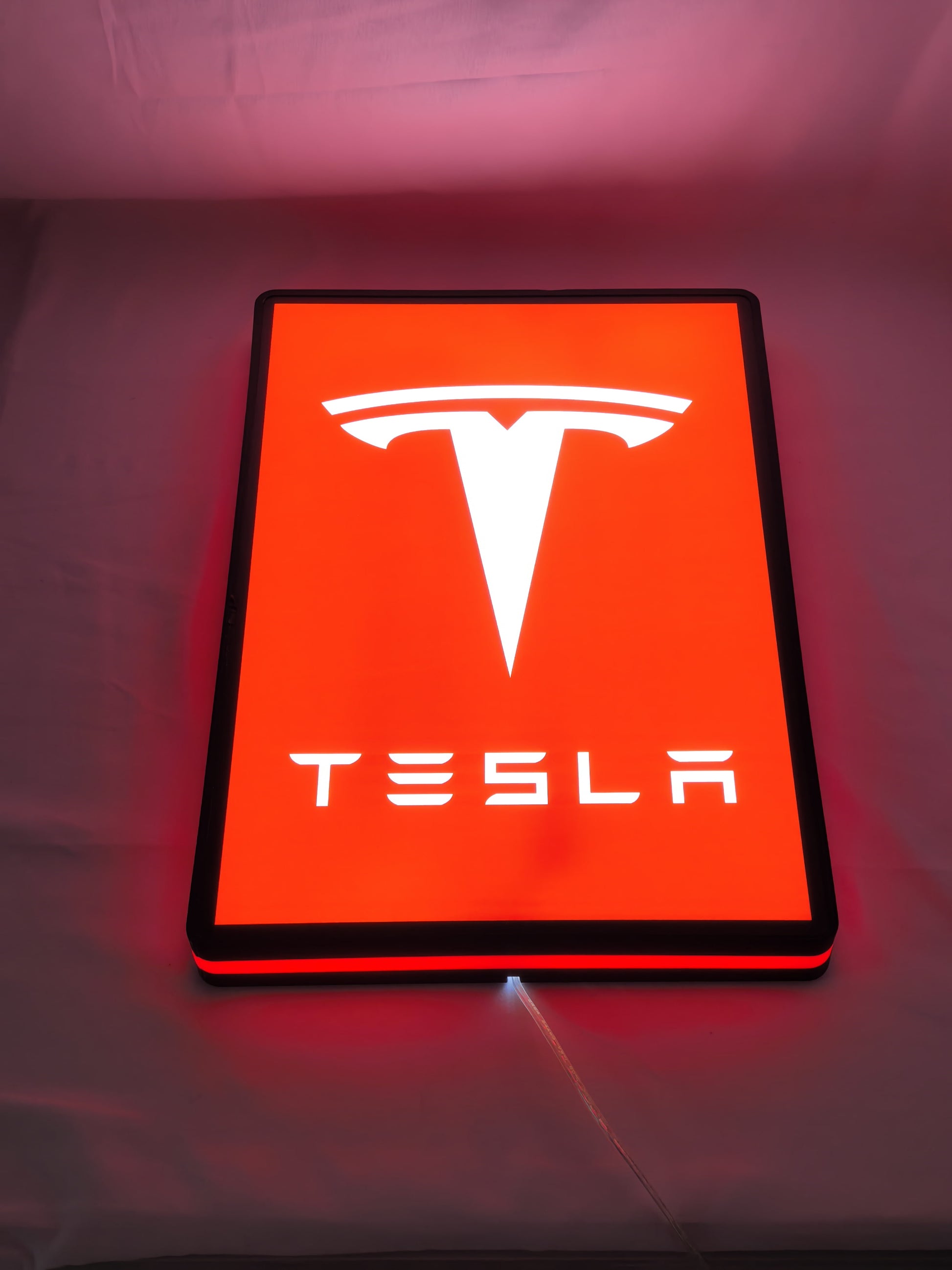 40cm Tesla 3D Printed Sign - Illuminated flat lay angled view, perfect for garage and man cave decor