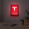 Tesla LED lightbox hanging on a room wall with soft red light