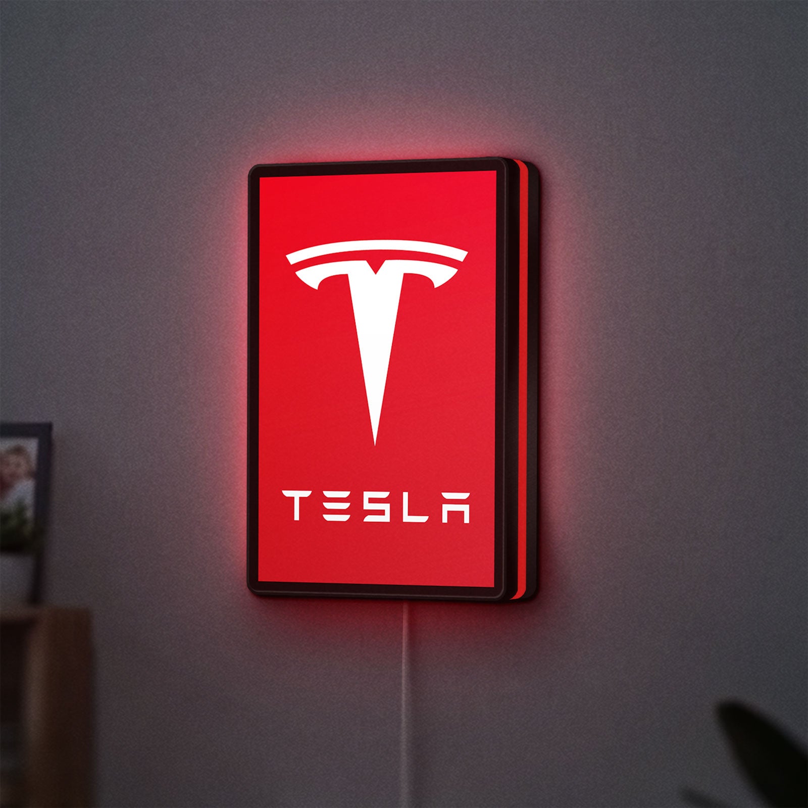 Tesla LED lightbox hanging on a wall with red glow