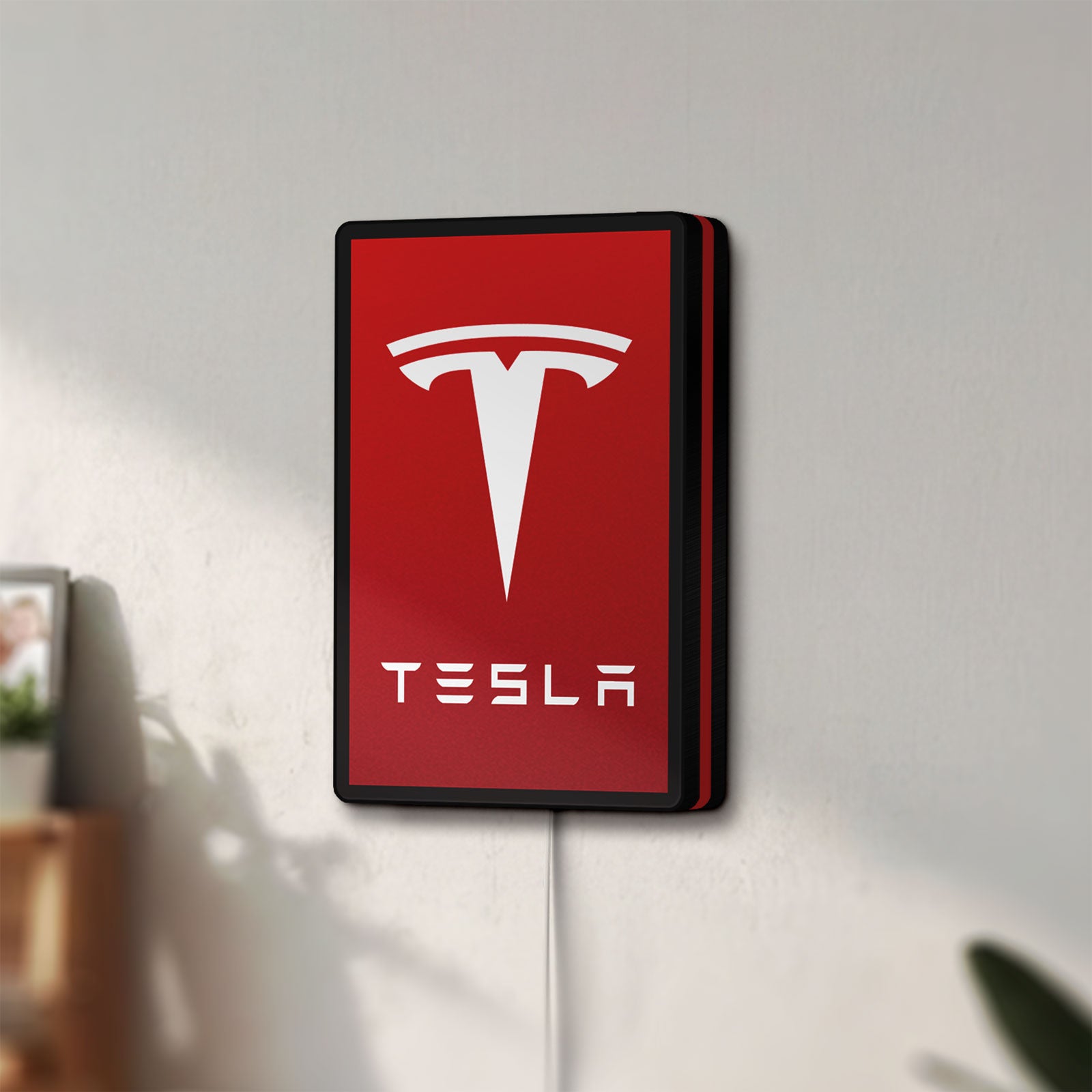 Unlit Tesla LED lightbox mounted on a wall in daylight