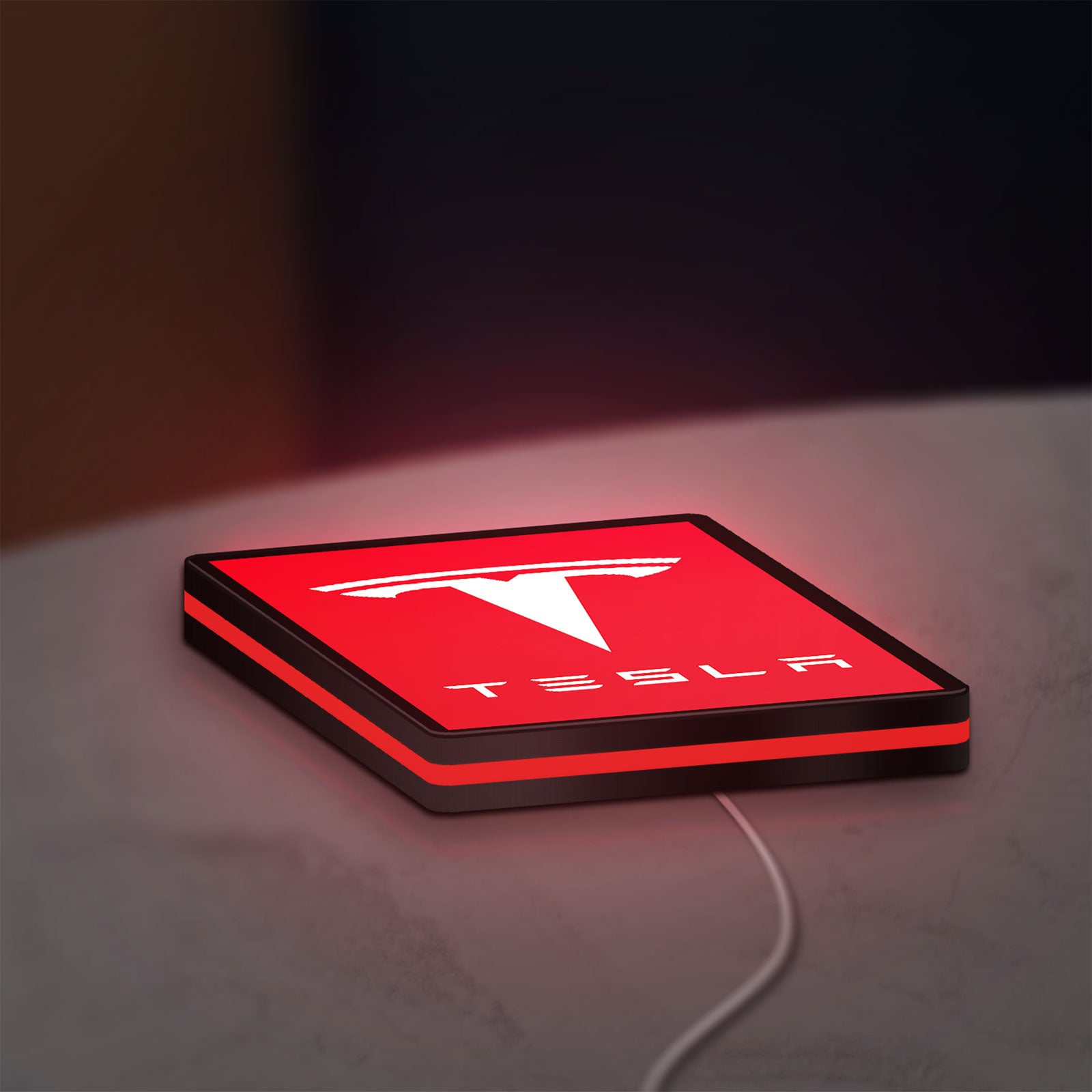 Tesla LED lightbox lying flat on a desk with red glow