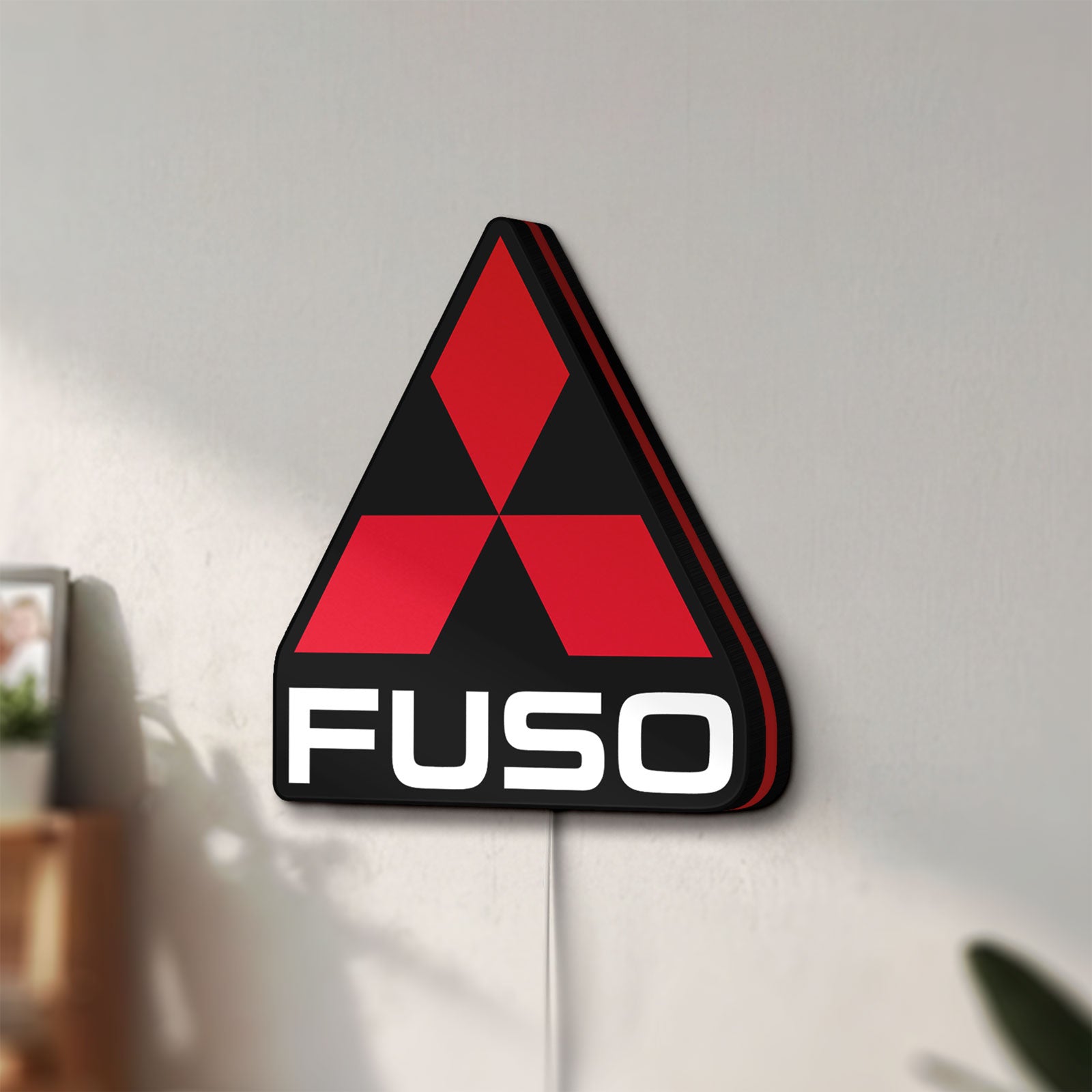 Unlit Fuso Truck LED lightbox mounted on a wall in daylight
