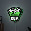Kawasaki Ninja Cup LED lightbox hanging on a wall with green glow