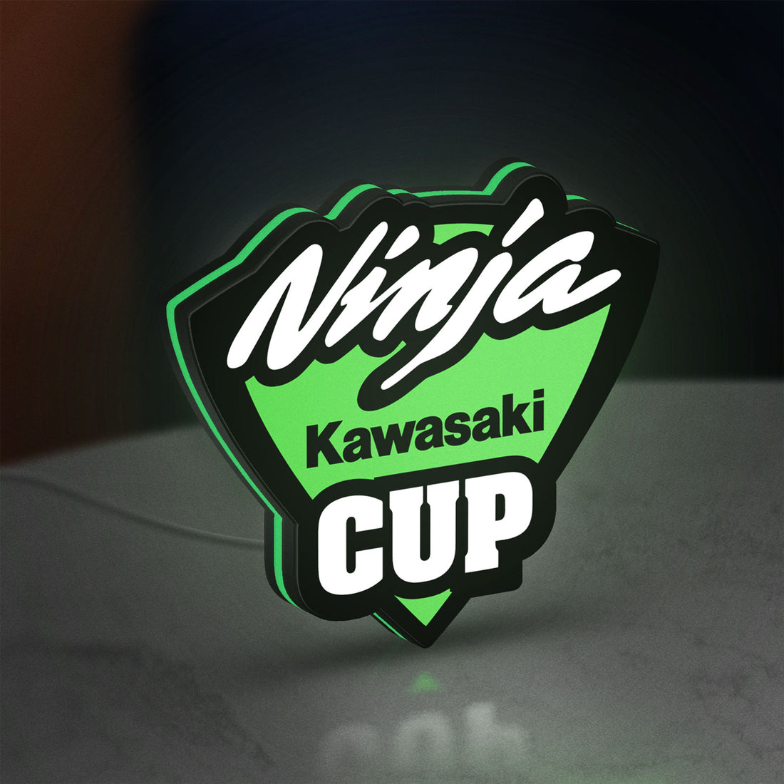 Kawasaki Ninja Cup LED lightbox hanging on a wall with green glow