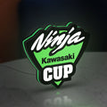 Kawasaki Ninja Cup LED lightbox standing on a desk from an angled side view with green glow