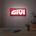 Givi Moto LED lightbox hanging on a room wall with soft red light