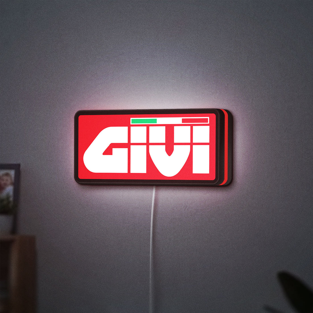 Givi Moto LED lightbox hanging on a wall with red glow