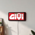 Unlit Givi Moto LED lightbox mounted on a wall in daylight