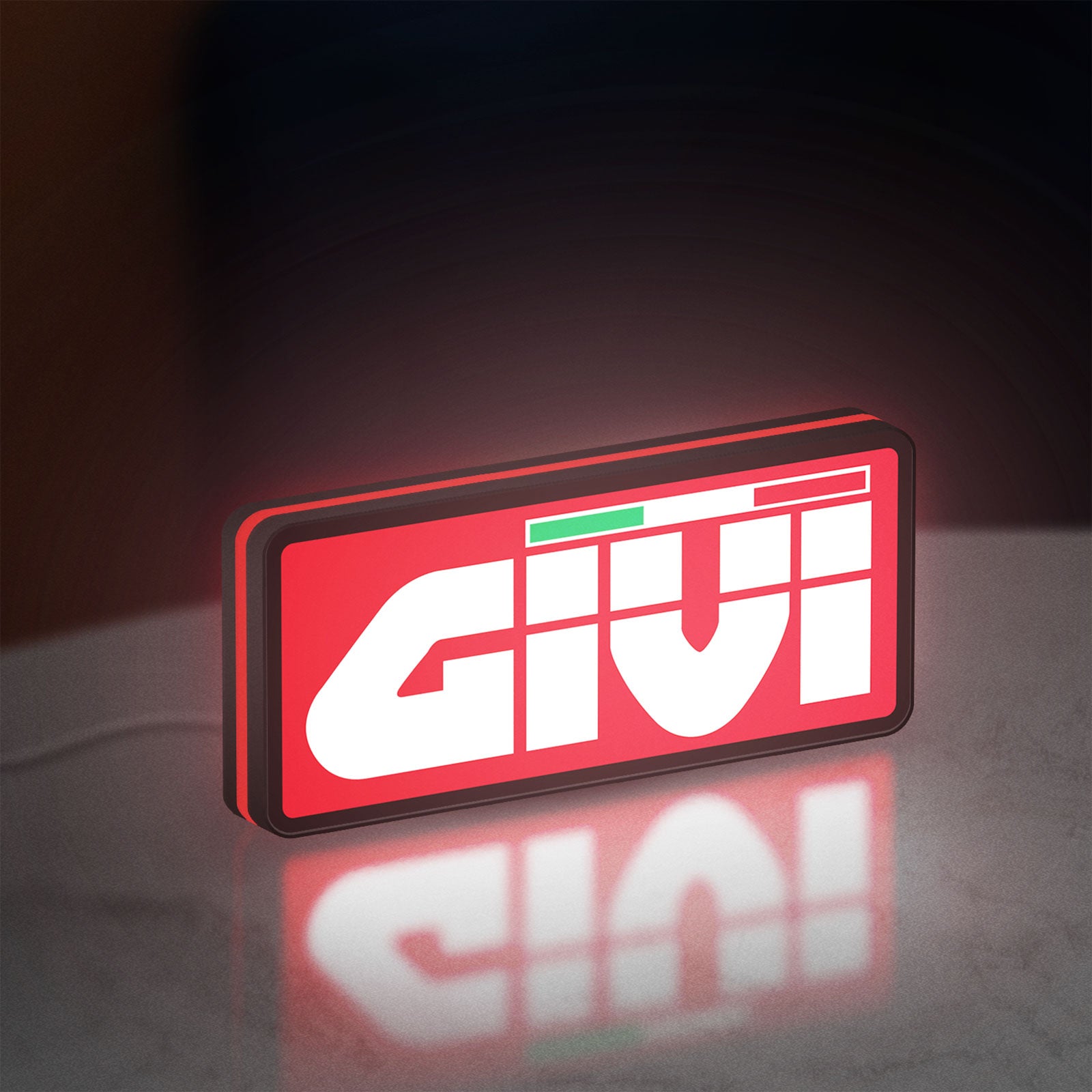 Givi Moto LED lightbox standing on a desk from an angled side view with red glow