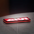Givi Moto LED lightbox lying flat on a desk with red glow