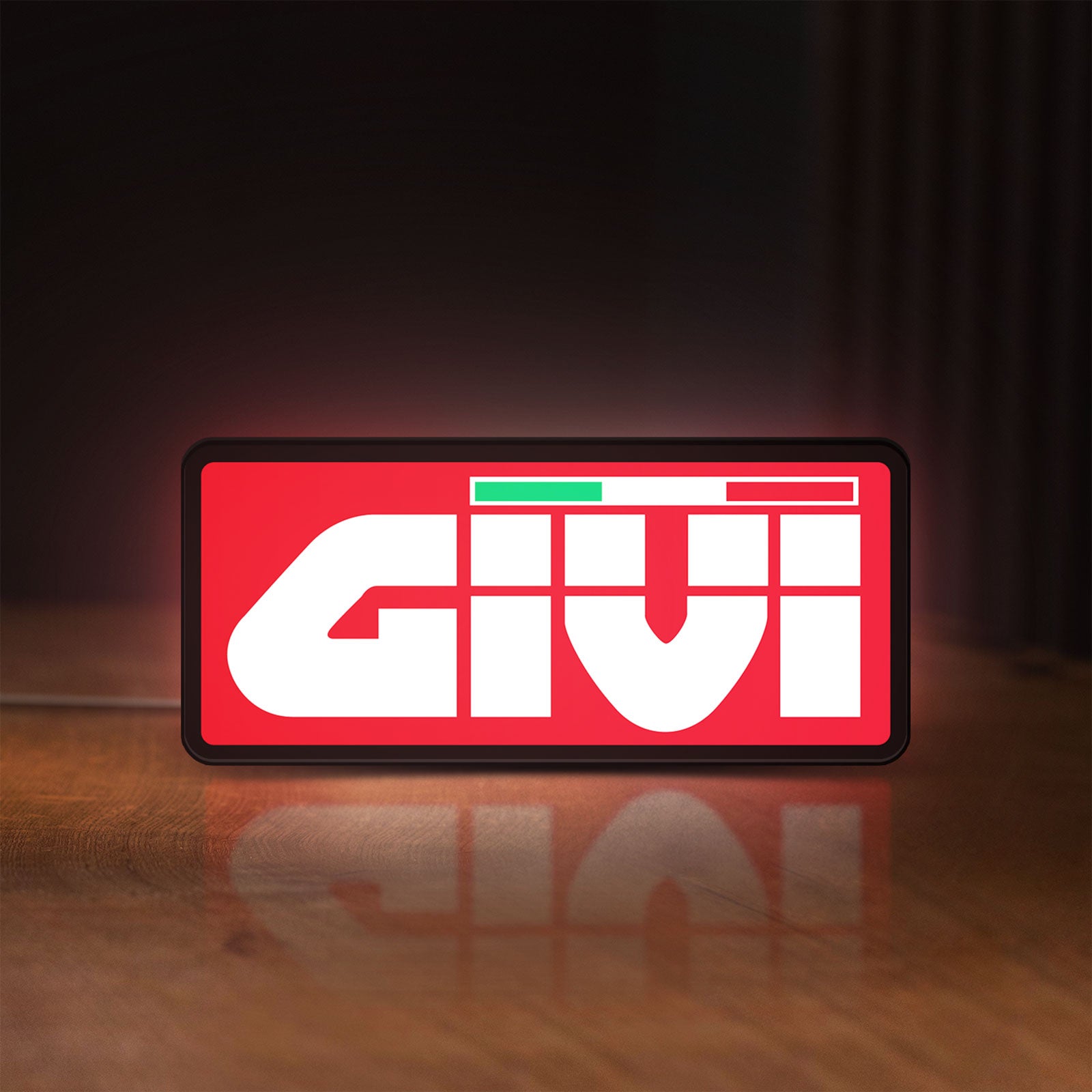 Front view of Givi Moto LED lightbox sign glowing on a wooden desk