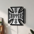 Unlit West Coast Choppers LED lightbox mounted on a wall in daylight
