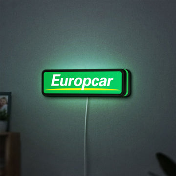 Europcar Sign LED lightbox hanging on a wall with green glow