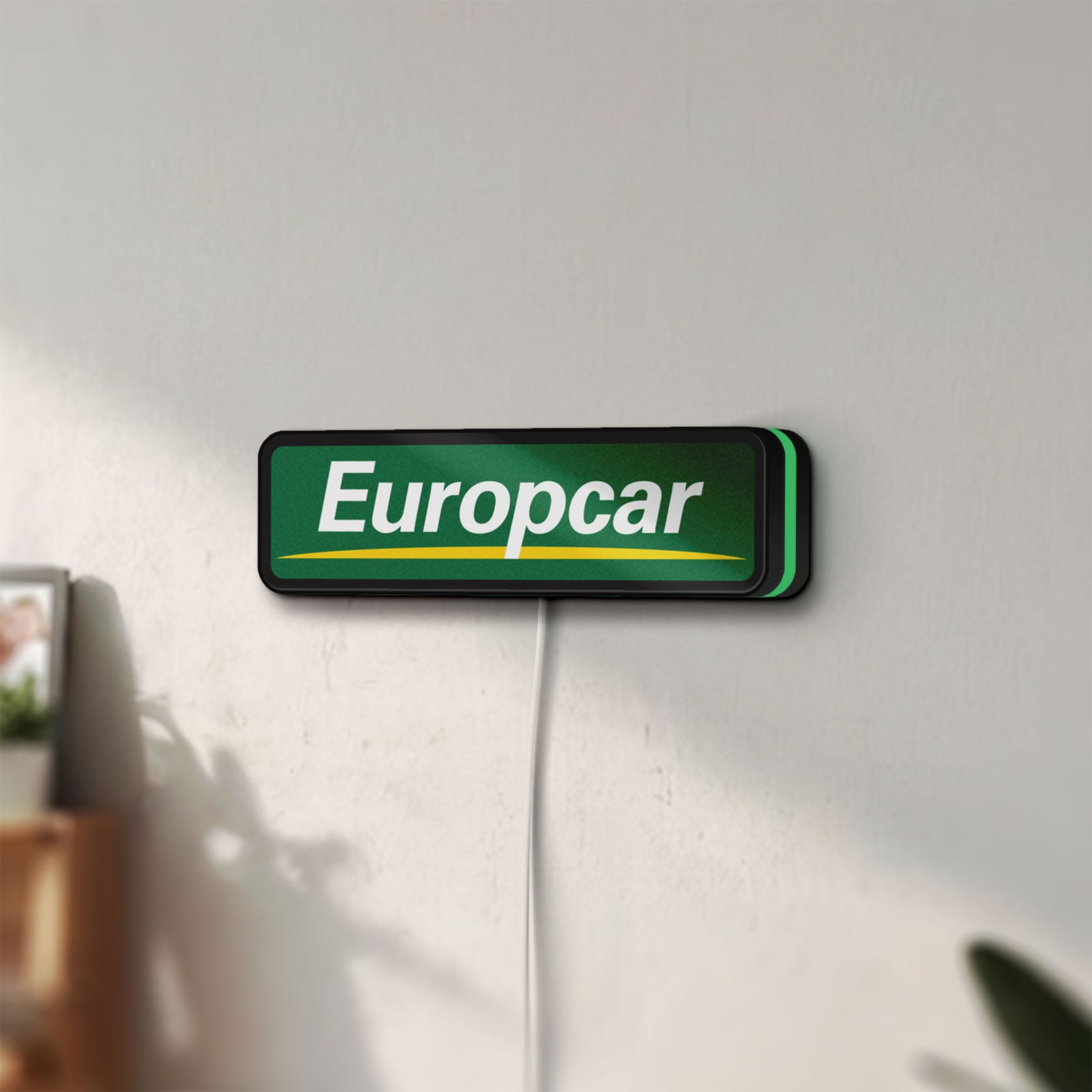 Unlit Europcar Sign LED lightbox mounted on a wall in daylight