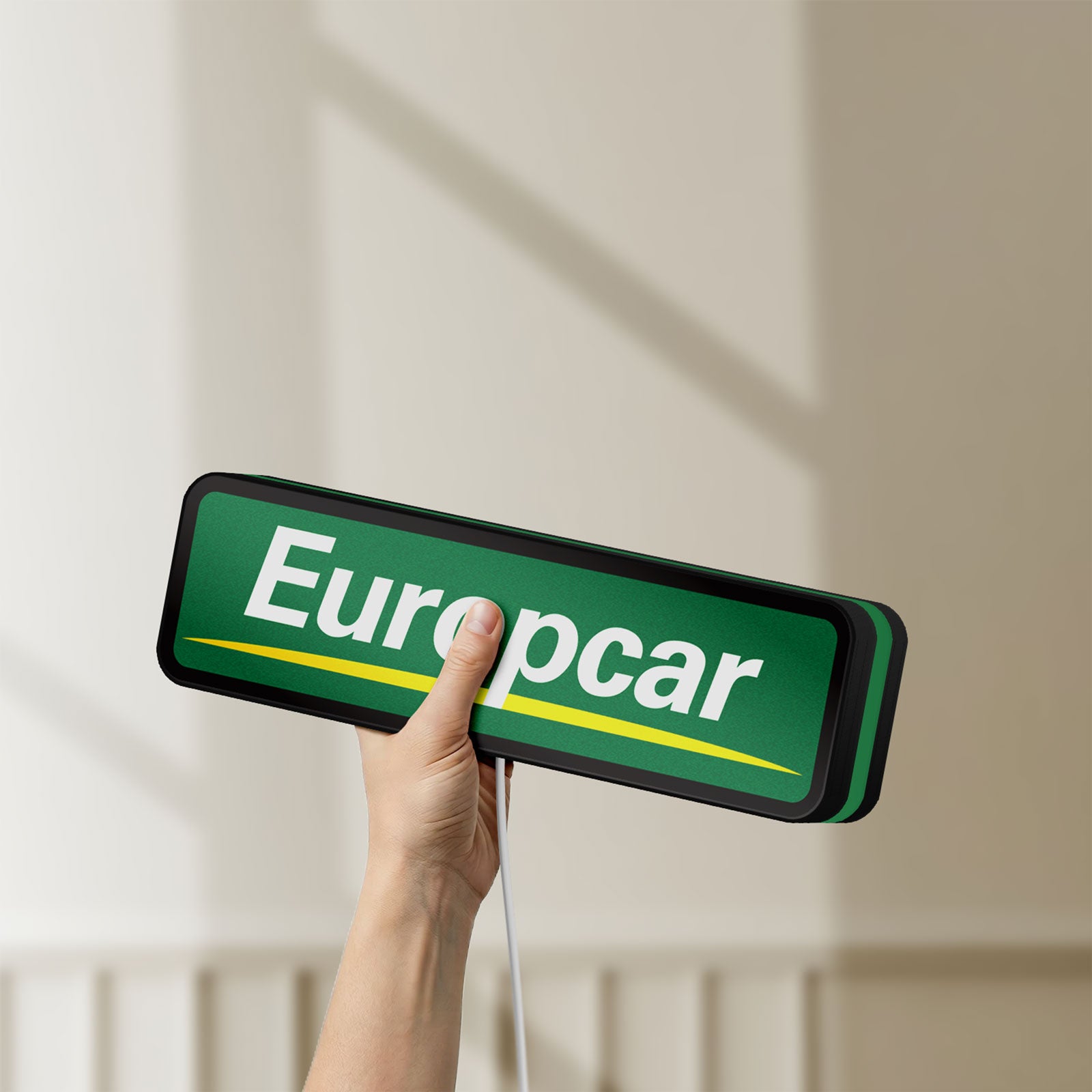 Unlit Europcar Sign LED lightbox held by hand to show size and details