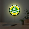 Lotus Cars LED lightbox hanging on a room wall with soft yellow light