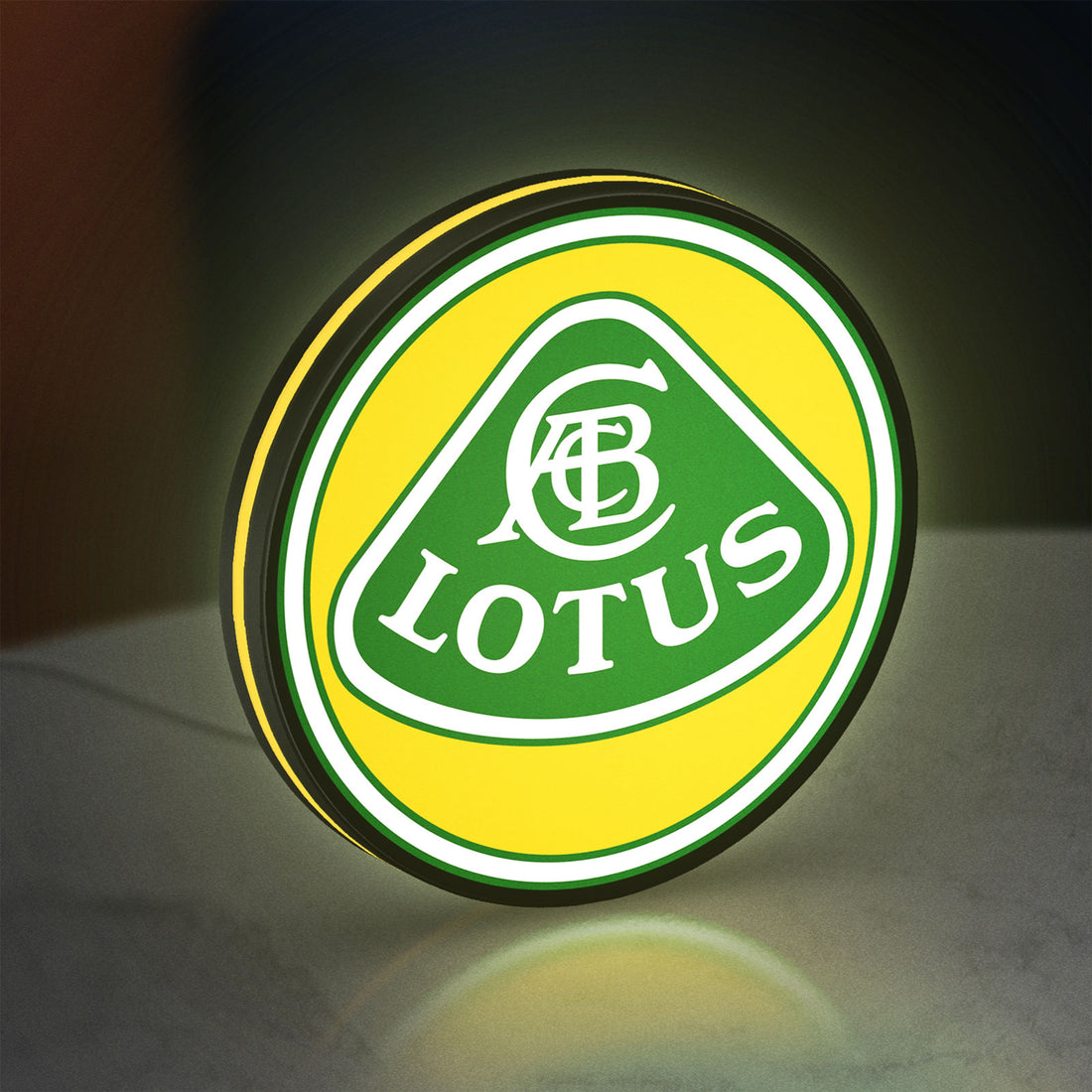 Lotus Cars LED lightbox hanging on a wall with yellow glow